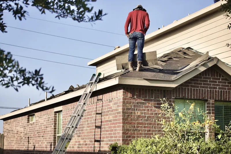 Professional roofer working on a residential roof in Peck Hill